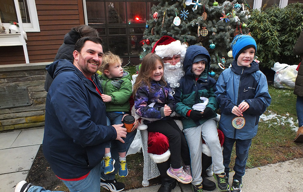 James Mullen and his children [L-R] Zachary, Madalynn, Ian and Thomas (TJ) pose with Santa.